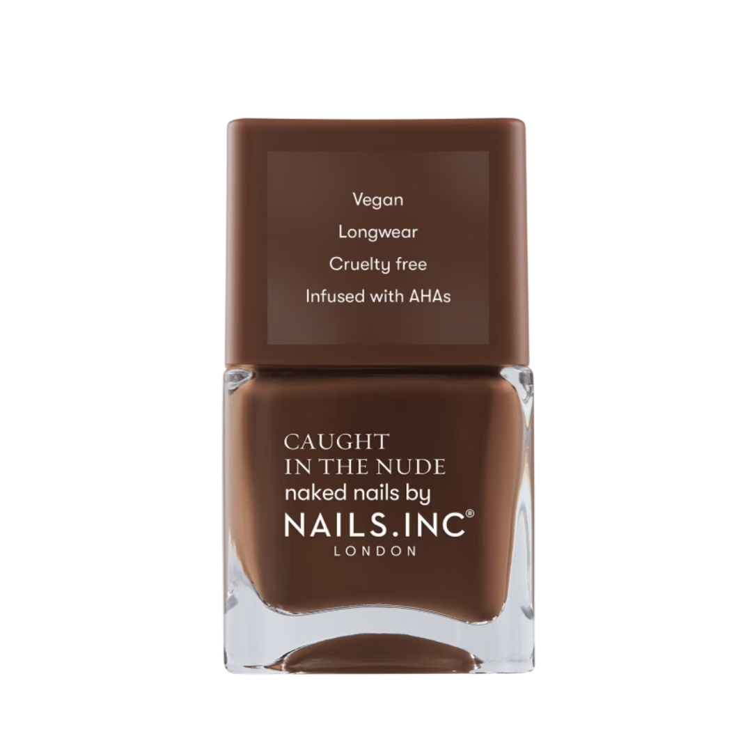 A product shot of the nails inc. Caught in The Nude Nail Polish in shade Hawaii Beach (a warm brown), on a white background