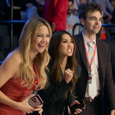 kate hudson brenda song drew tarver and more as the waves basketball team owners standing sideline at a game in the tv show running point