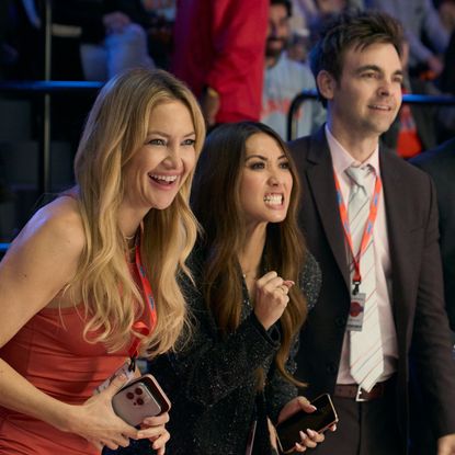 kate hudson brenda song drew tarver and more as the waves basketball team owners standing sideline at a game in the tv show running point