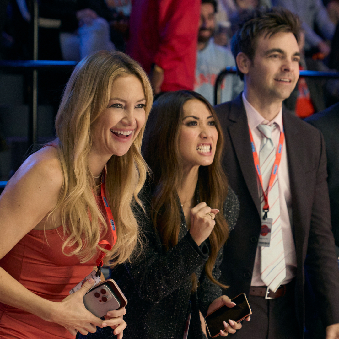 kate hudson brenda song drew tarver and more as the waves basketball team owners standing sideline at a game in the tv show running point