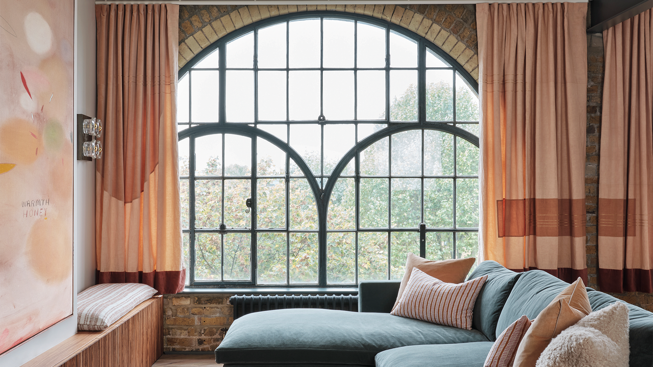 Large window framed by peach curtains.