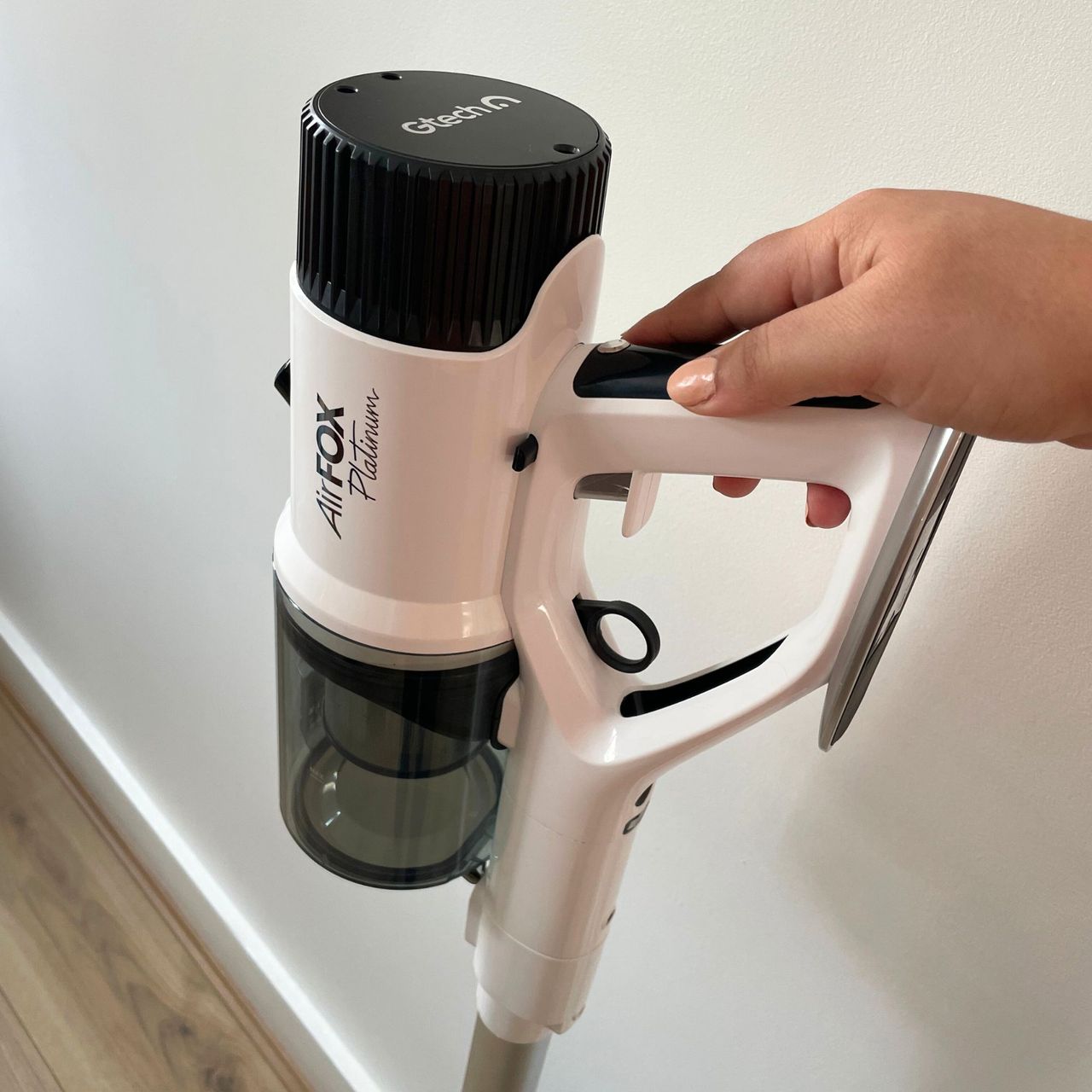 Hand holding up the top portion of the Gtech AirFOX Platinum Cordless Vacuum
