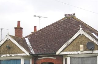 faded diamond asbestos roof tiles on a bungalow