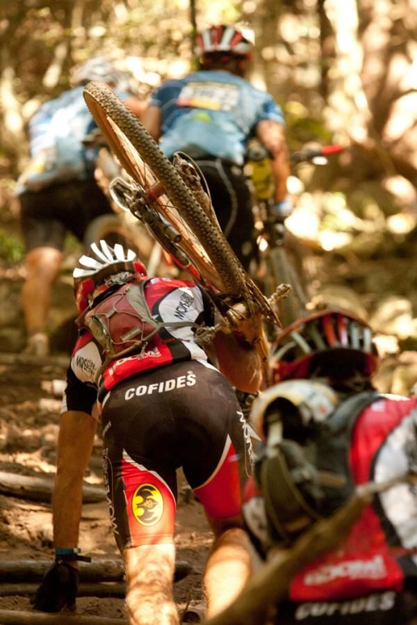 A portage section takes its toll on riders, fprsing them to carry their biked out o f a gorge during stage 1 of the 2011 Absa Cape Epic Mountain Bike stage race held from Saronsberg Wine Estate in Tulbagh, South Africa on the 28 March 2011