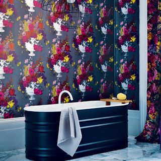 black florals wallpaper in bathroom and freestanding bath