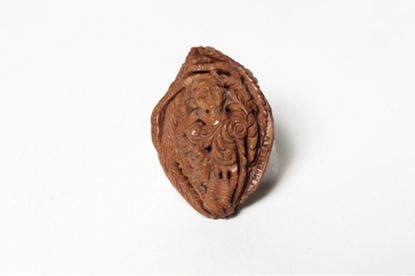 A carved peach pit