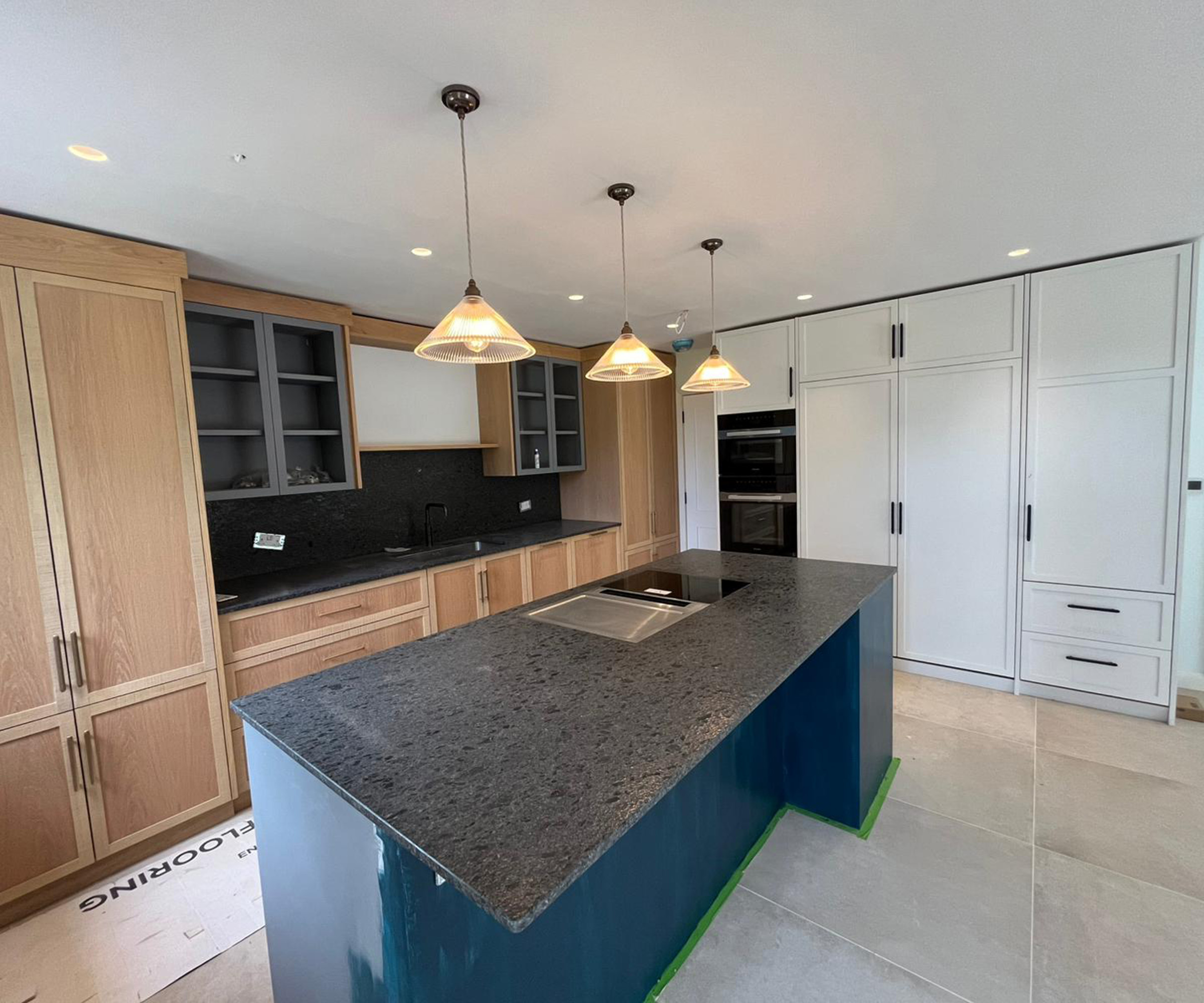 A newly fitted kitchen with wooden cabinets