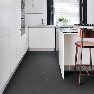 Dark vinyl floor in white kitchen