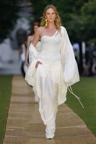 A model walks down the Prabal Gurung runway in an all white outfit Beyonce wore for the Cered party