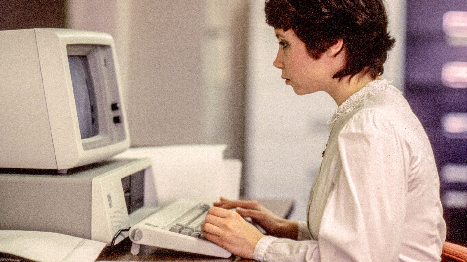 A worker using an Acorn computer by IBM, 1981