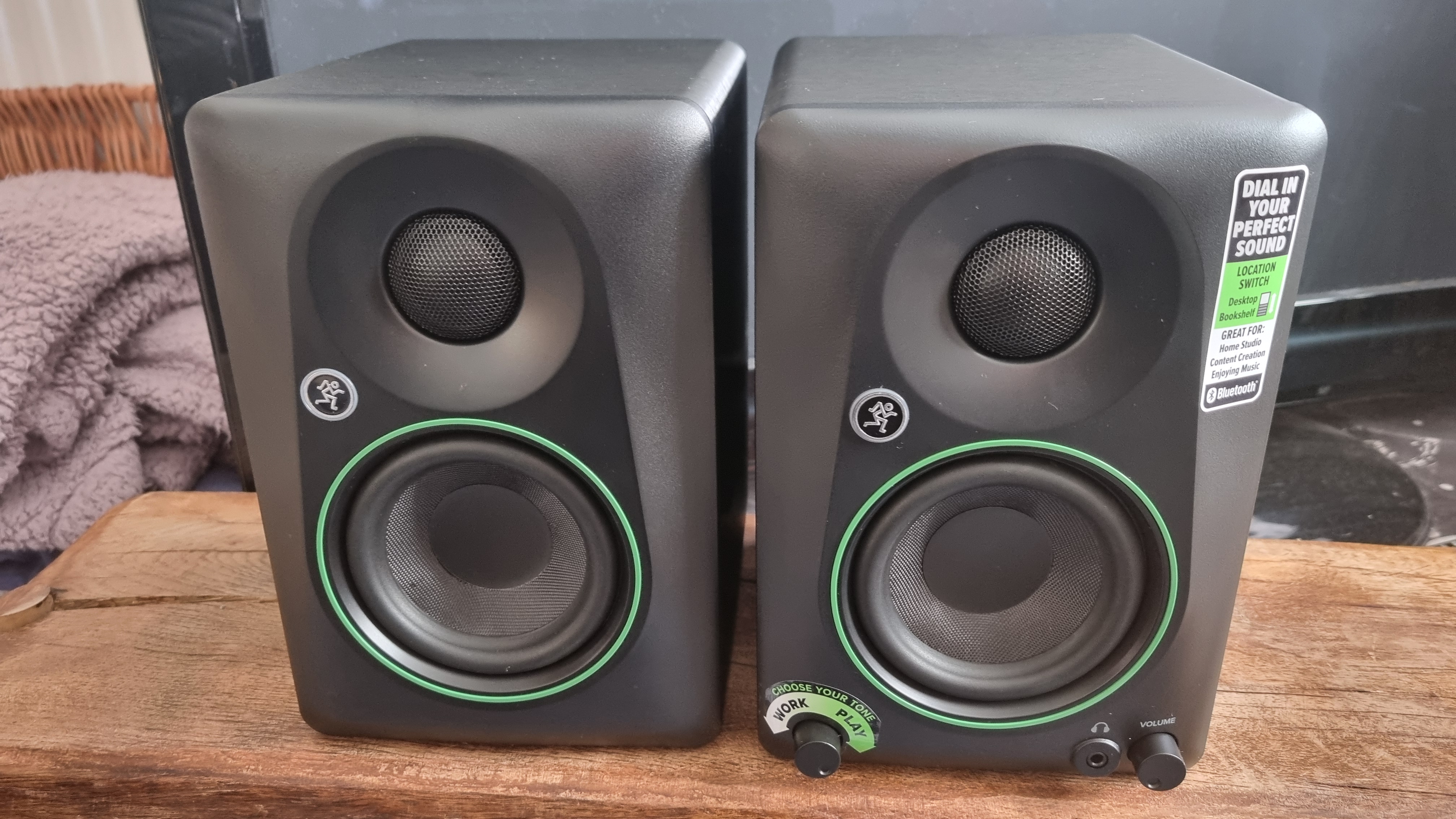 Two Mackie CR3.5 BT speakers on a wooden plinth