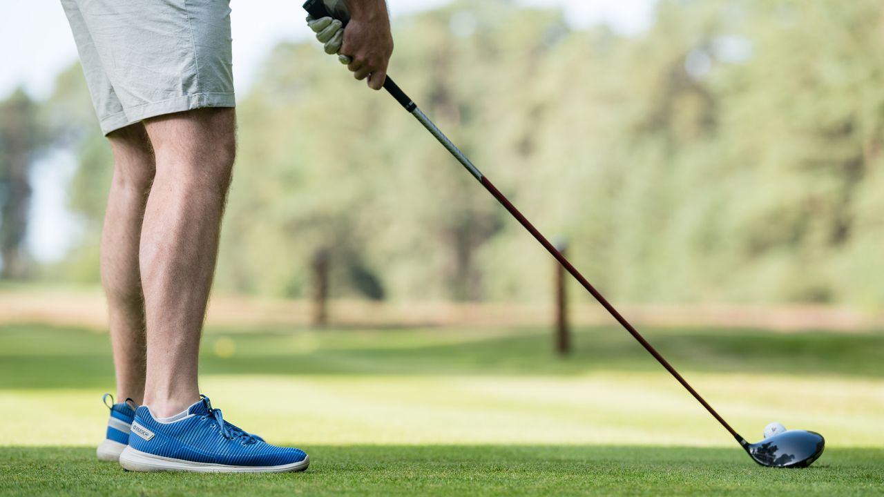 Golfer sets up for a drive