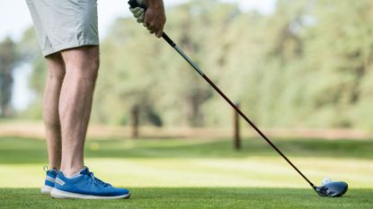 Golfer sets up for a drive