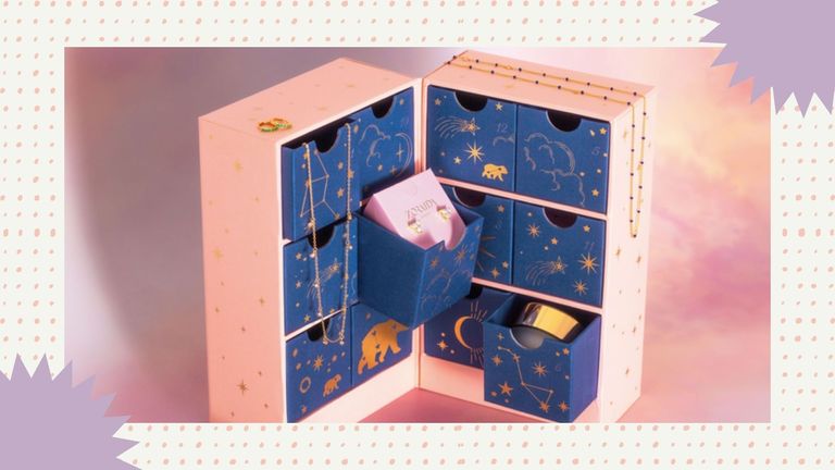 The best jewelry advent calendars of 2021 featuring the Catherine Zoraida 12 Days of Christmas Advent Calendar shown on a patterned background