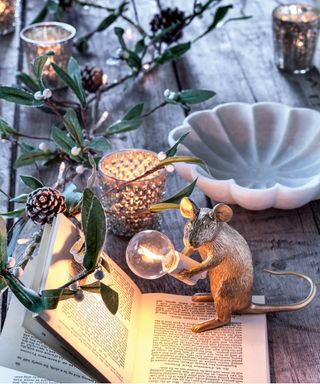 Christmas table with open book and mouse lamp