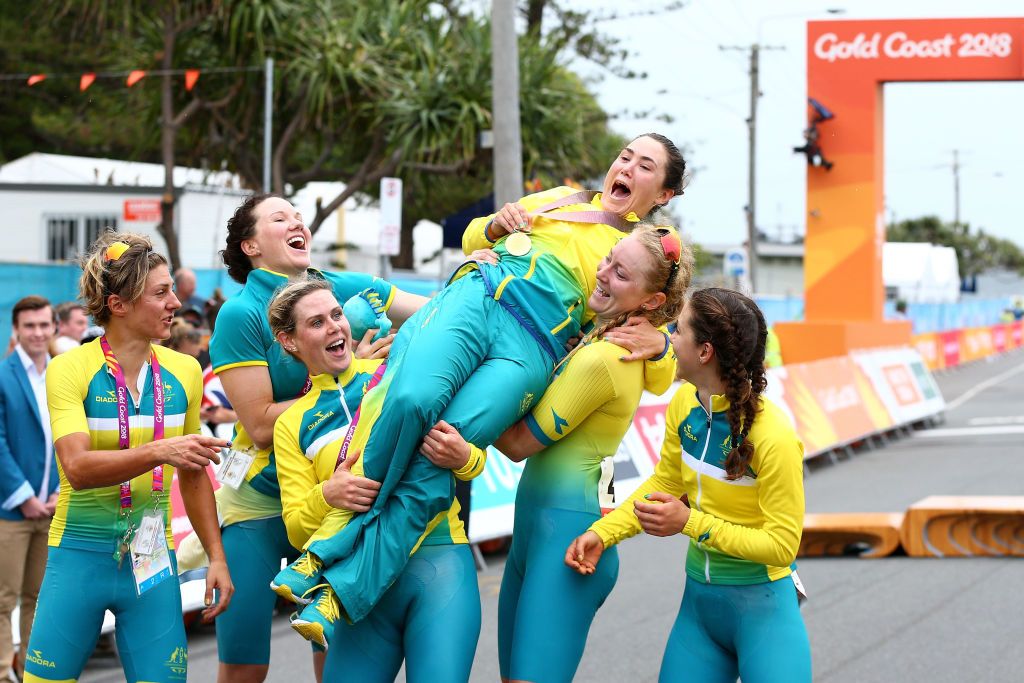 Chloe Hosking is hoisted aloft by her jubilant teammates