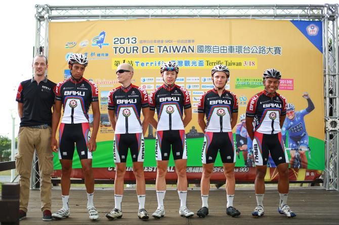 the Synergy Baku Cycling Project on the start line with rider/directeur sportif David McCann, David Clarke, John Ebsen, Christoph Schweizer, Kirill Pozdnyakov and Anuar Manan.