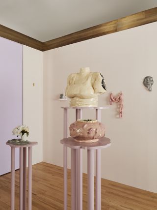 Exhibition of white and pink ceramic vessels on tall pink plinths, created by Malkia Williams and shown at Materia during New York Design Week 2024