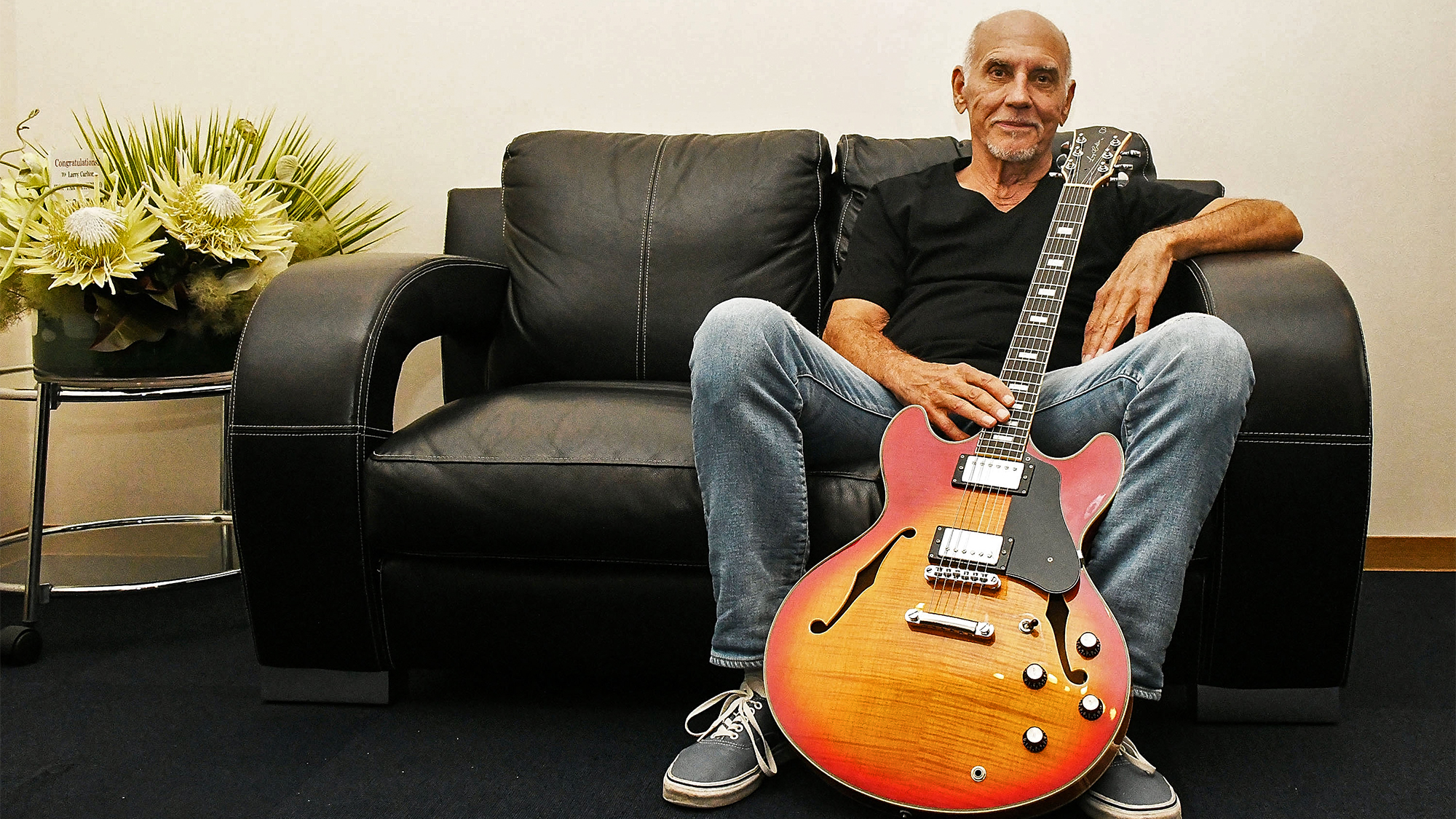 Larry Carlton poses holding his signature guitar 'Sire Larry Carlton H7' backstage during 'The Crusaders Remembered &amp;amp; Greatest Hits Steely Dan' at Billboard Live on June 9, 2022 in Tokyo, Japan.