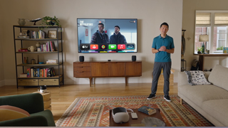 Apple tvOS 18 being discussed by presenter in living room setting