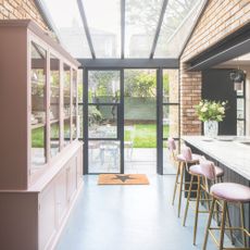 Open plan kitchen diner with partially glazed roof, and steel doors to the back garden