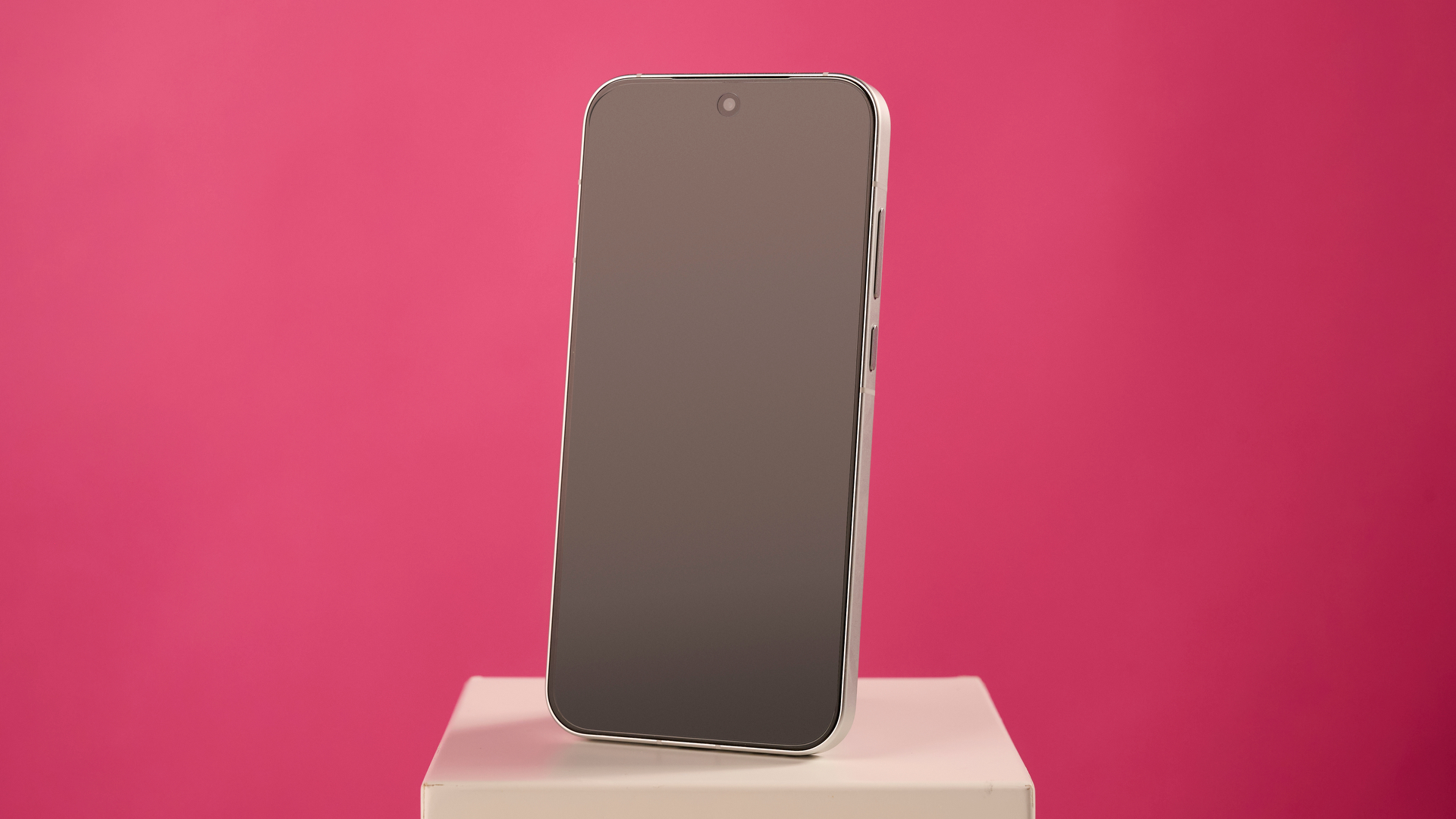 Oppo Reno 16 5G on stand against pink background
