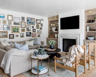 neutral living room with checked sofa, gallery wall, fireplace and bespoke storage