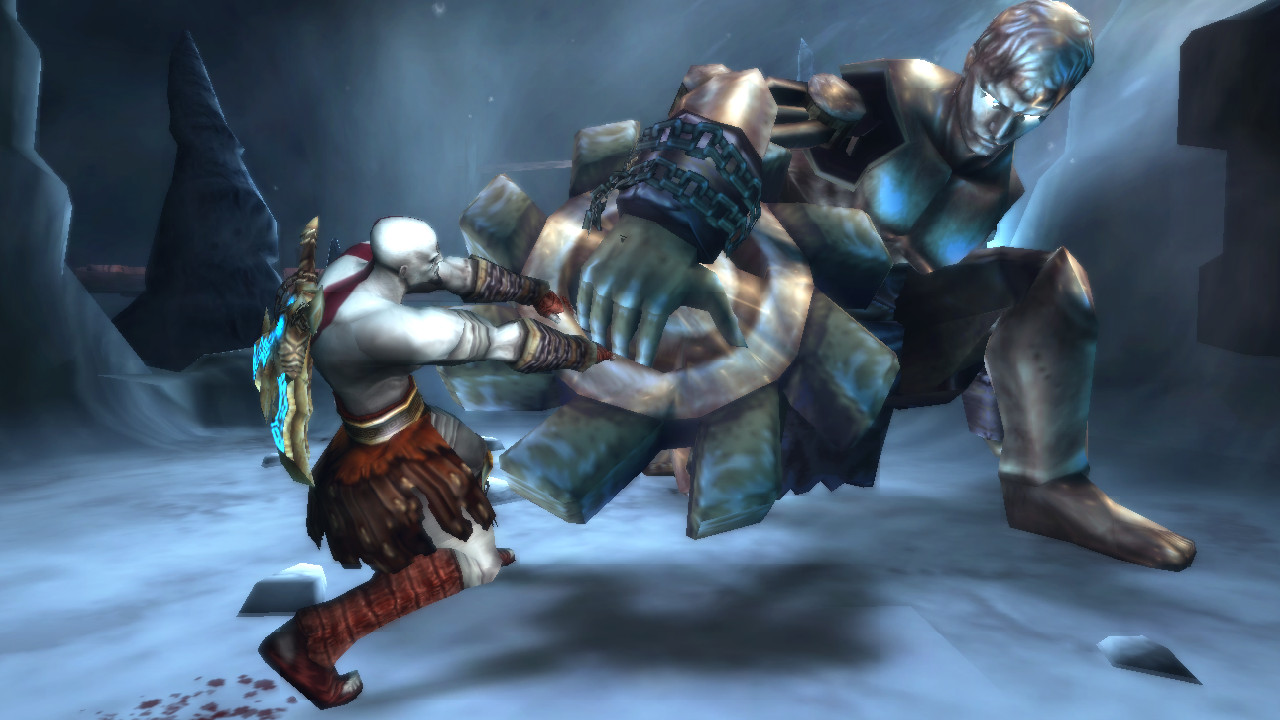 Kratos battles a metal giant in the ice mountains in God of War: Ghost of Sparta