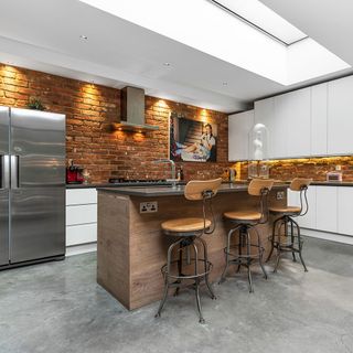 kitchen with brickwork and industrial bar stools