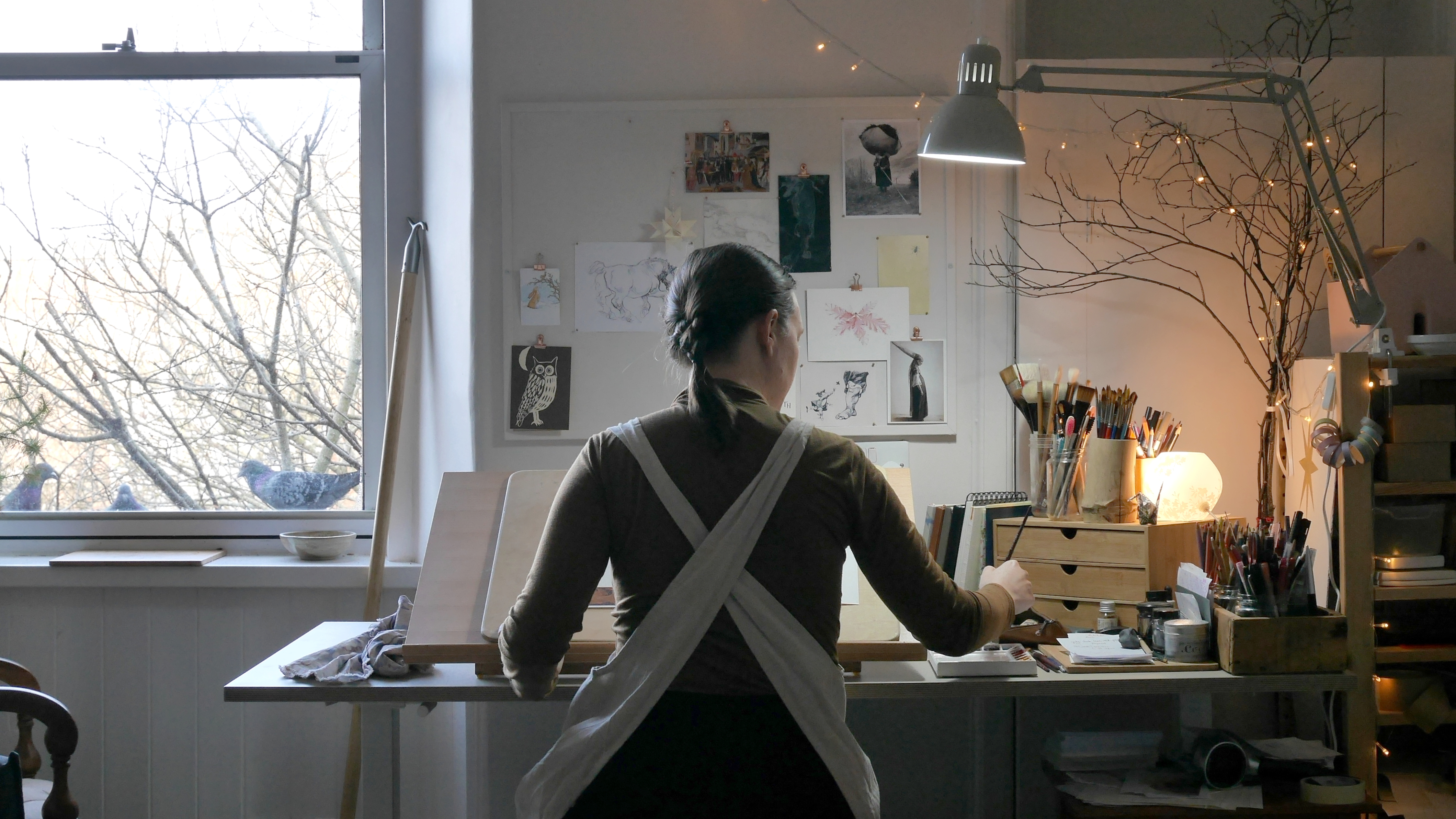 Artist in residence; A woman sits at a desk