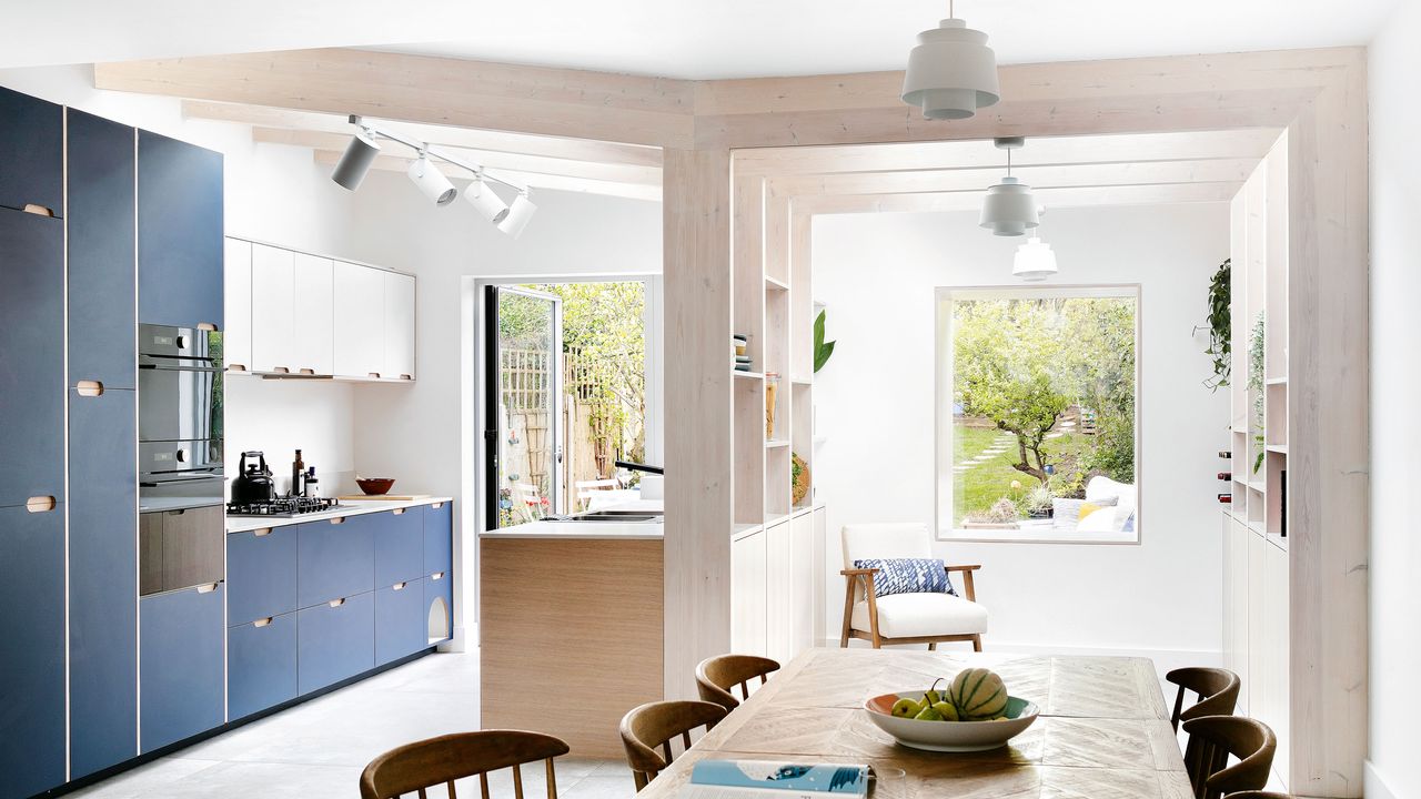 broken plan kitchen design blue and white kitchen living space separated by a timber divider