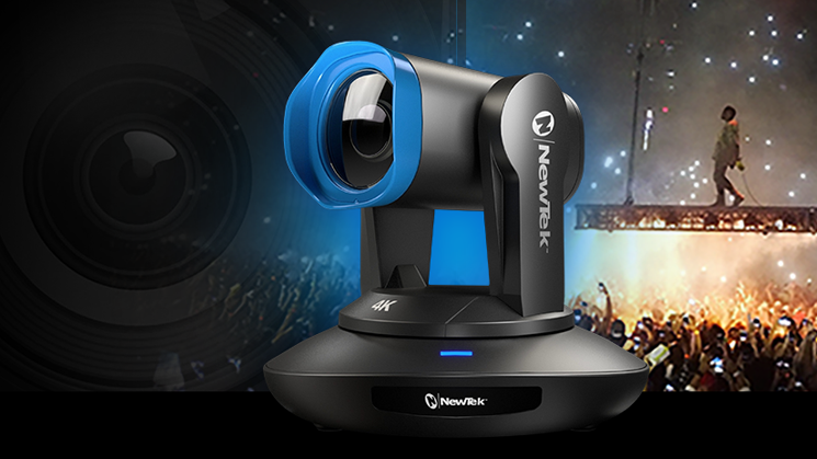 The new NewTek NDI camera with a blue frame around the lens propped in front of a stage with a musical artist walking over the audience on a catwalk.