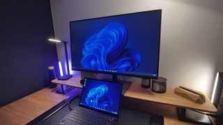 BenQ PD3205U Monitor in a low-lit home office with a laptop in front