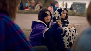 Eve Hewson as Becka Garvey sitting on the side of the road during the Apple TV Plus show, Bad Sisters.