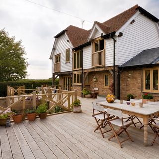 large decking outside house with wooden floor and railing