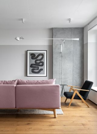 A living room with a pink sofa