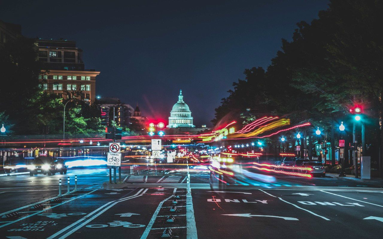 A view of the Capitol Building from street level at night in Washington, DC