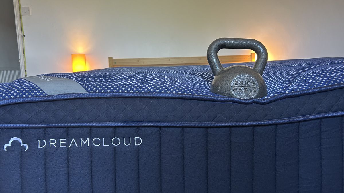 A weight resting on the edge of the DreamCloud Luxe Memory Foam mattress to measure edge support