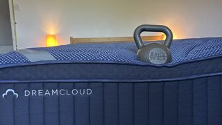 A weight resting on the edge of the DreamCloud Luxe Memory Foam mattress to measure edge support