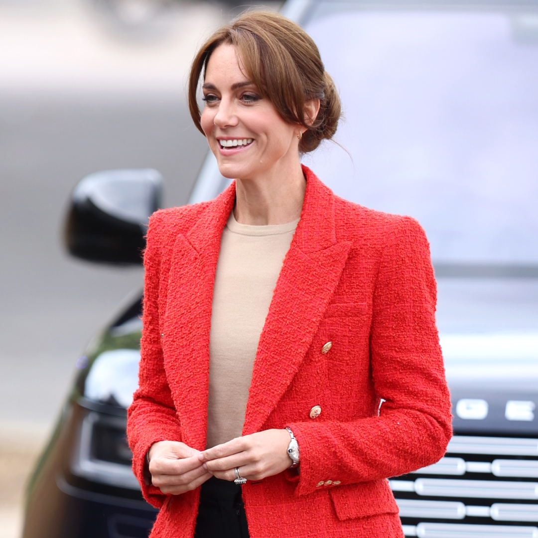 Princess Kate wearing a red blazer and smiling
