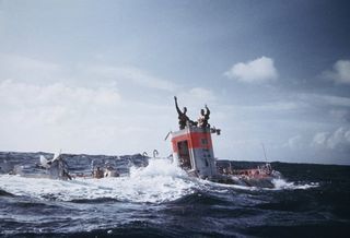 Jacques Piccard and Don Walsh emerge from the bathyscaphe Trieste following their successful manned descent to the bottom of the Mariana Trench in January 1960. In the coming weeks, James Cameron will attempt to make the second successful manned dive to the deepest part of the ocean aboard the Deepsea Challenger.