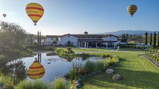 A hot-air balloon in the sky over the Avensole Winery in Temecula, California