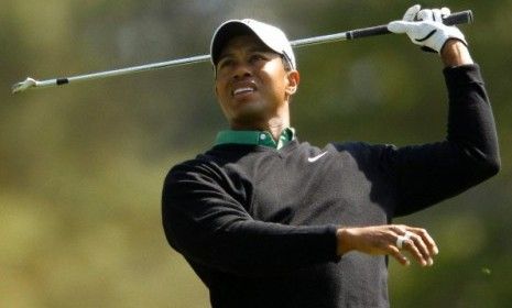 Tiger Woods watches a shot on the fourth hole of the games.