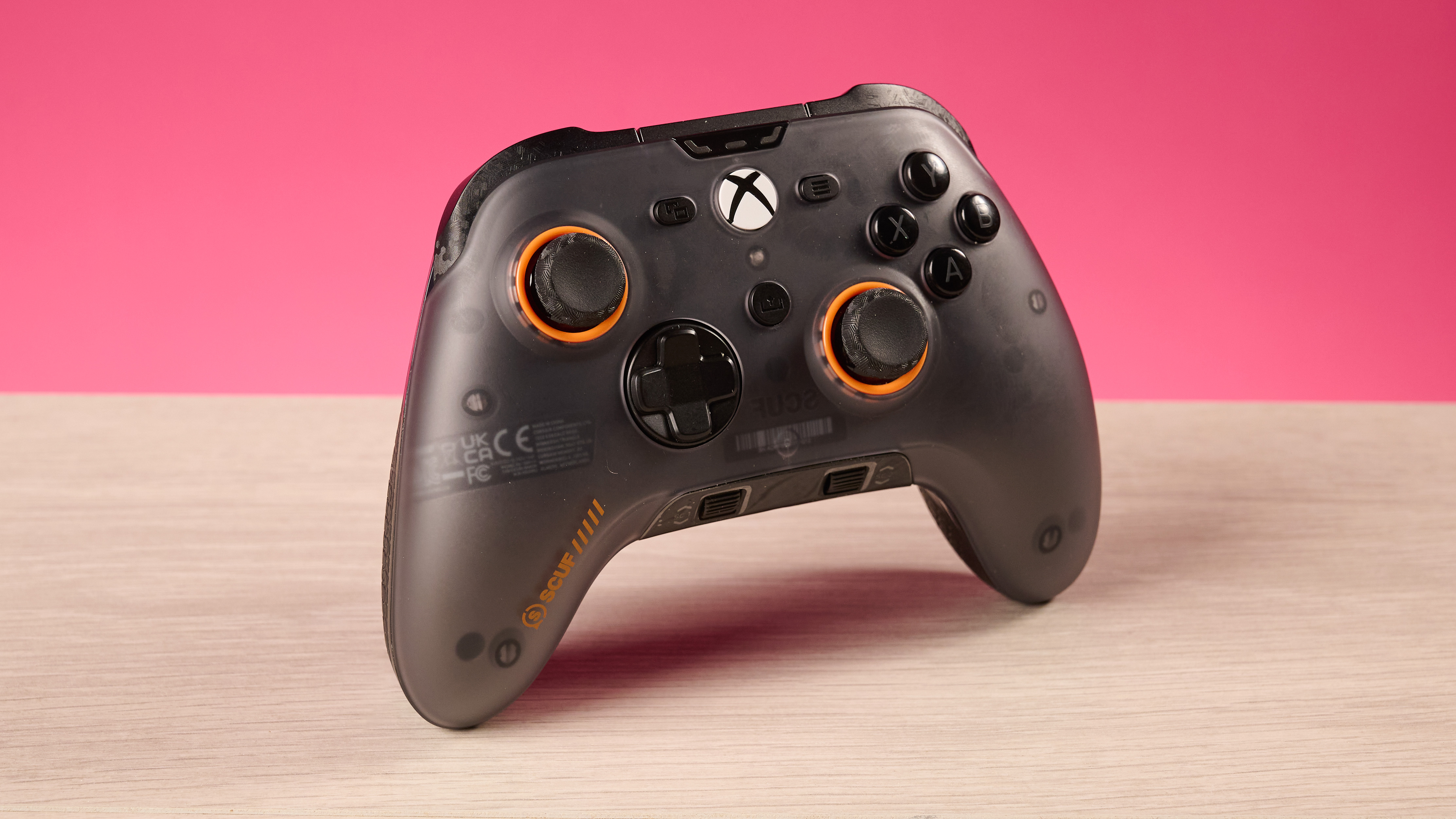 The Scuf Valor Wired with TMR in front of a pink background.