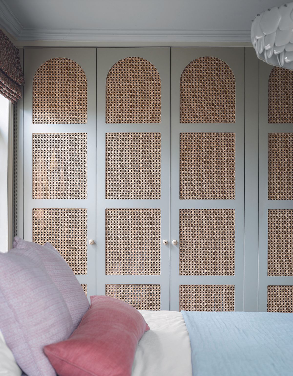 A small bedroom with a built-in wardrobe