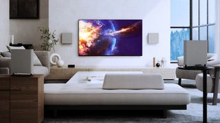 Sony Bravia TV mounted on a wall with a sci fi explosion on screen, with the Bravia quad wireless speakers placed around the room