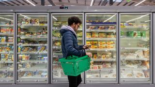man shopping in the frozen aisle of the supermarket