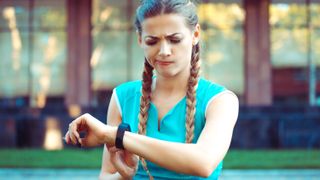 Unhappy woman with fitness tracker