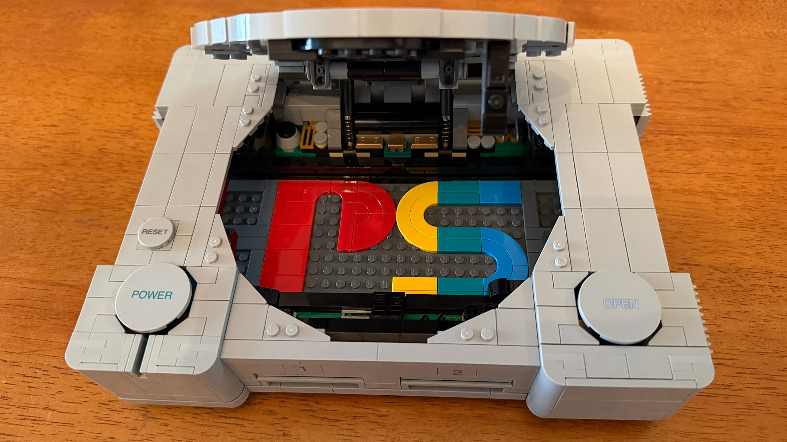 The Lego PlayStation #72306 with disc tray lid open showing PS logo inside