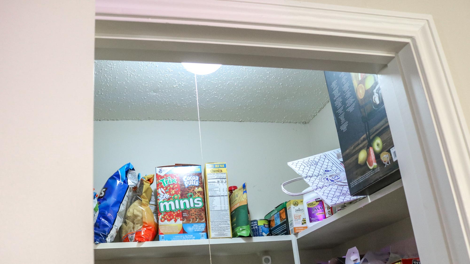 A pantry with a smart light bulb and a motion sensor to turn it on